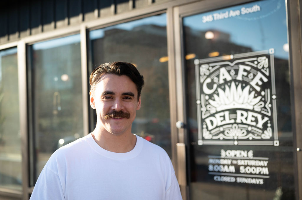 CCDF client Devereaux Gatin standing in front of his cafe - Cafe Del Rey