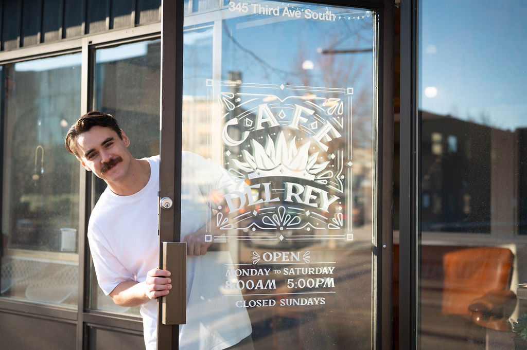 CCDF client Devereaux Gatin standing in front of his cafe - Cafe Del Rey